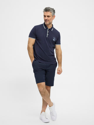 Navy kortærmet polo fra Redgreen i 100 % bomuld med kontraststribet krave og ærmekant samt lille sejlskibslogo.